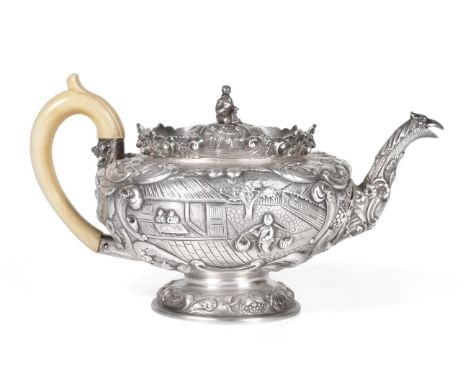 A George IV Chinoiserie Silver Teapot, Joseph Angell, London 1824, circular on domed pedestal foot, chased and engraved with 