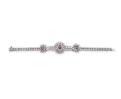 A Ruby and Diamond Bracelet, an oval cut ruby in a claw setting within a three tier border of round brilliant cut diamonds, b