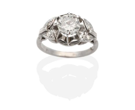 An Early 20th Century Diamond Solitaire Ring, an old cut diamond in a claw setting, to decorative diamond set shoulders, prin