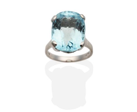 An 18 Carat White Gold Aquamarine Ring, an oval cut aquamarine in a claw setting, to straight shoulders, finger size M see il