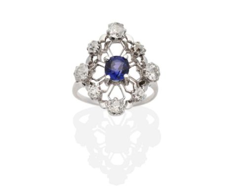 An Early 20th Century Sapphire and Diamond Navette Ring, an oval cut sapphire in a claw setting, within a pierced knife edge 