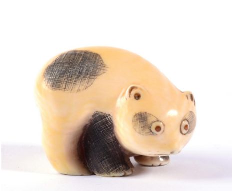 A Japanese Ivory Netsuke, Meiji period, as a panda with amber eyes, 4.5cm long