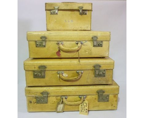 4 Vintage Luggage Trunks Initialled S.A.W, Lemon coloured leather trunks with peach silk lining.Consists of Large Trunk with 