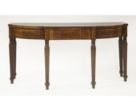 A George III mahogany serving table,of 'broken bow' shape, the top with broad satinwood crossbanding, on reeded legs,168cm wi