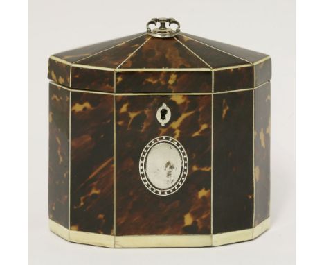 A George III tortoiseshell single compartment tea caddy,the ten-sided top and body with ivory stringing and borders, the fron