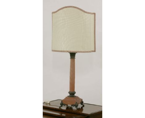 A marble and metal-mounted table lamp, with a Corinthian capital over a spiral cut column, on a square plinth, raised on scro