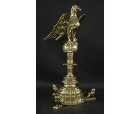 A Victorian brass lectern,dated 1884, of usual form with an eagle holding a book rest on its outspread wings, standing on a g