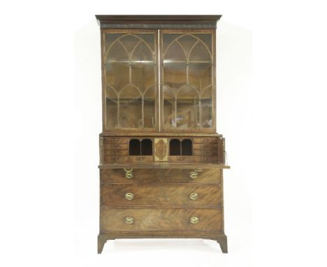 A George III mahogany secretaire bookcase cabinet,the upper section with crossbanded and glazed doors over the base, with dou