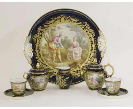 A Sèvres-style cabaret set, painted with fête champêtre scenes after Watteau, on a blue ground with gilt borders comprising: 