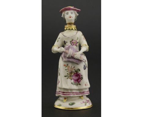 A Chelsea gold-mounted porcelain scent bottle,modelled as a lady playing a hurdy-gurdy, her head forming the stopper, with 18