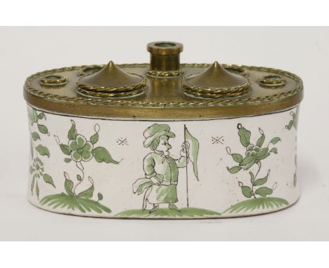 A Moustiers faience inkstand, 19th century, of oval shape, the brass top with two hinged inkwells and five apertures, the bod