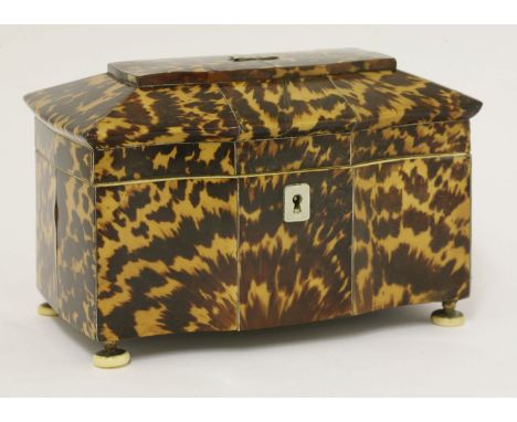 A George III serpentine-fronted tortoiseshell tea caddy,sarcophagus top opening to reveal two covered divisions within, stand