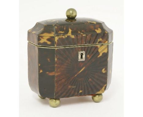 A George III tortoiseshell single compartment tea caddy,having a moulded sunburst panel to the front, pewter stringing, a dom