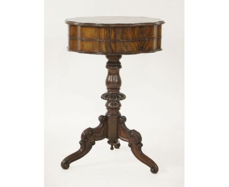 A Victorian inlaid walnut circular worktable,the wavy edged hinged top opening to reveal fitted compartments with a pincushio