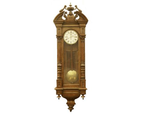 A walnut 'Vienna Regulator' wall clock,19th/20th century, with a carved crest and a three-train weight-driven movement,135cm 