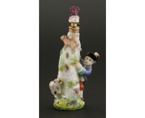 A Chelsea porcelain scent bottle,modelled as a boy and his dog chasing a squirrel around a tree trunk, now with dragonfly sto