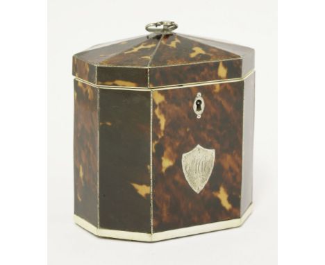 A George III tortoiseshell single compartment tea caddy,octagonal with pewter stringing, ivory borders and an applied white m