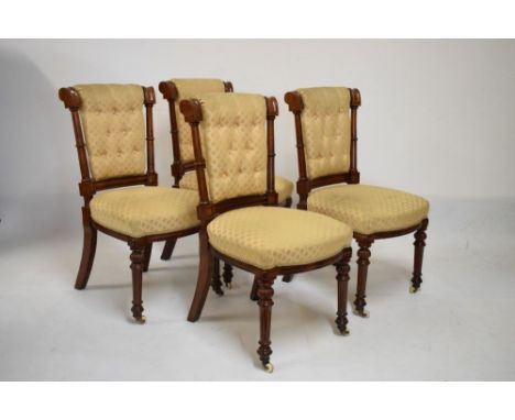 Set of four Victorian oak dining chairs having button back and stuff over seats on turned front supports  