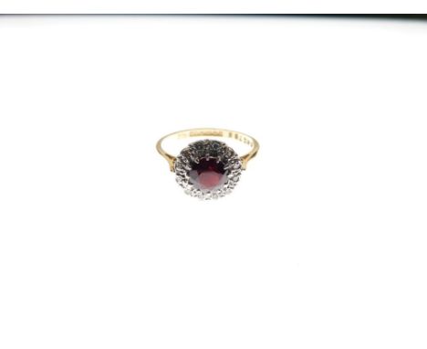 18ct gold cluster ring, the central red stone within a border of twelve small diamonds, size O½, 4.2g gross approx  