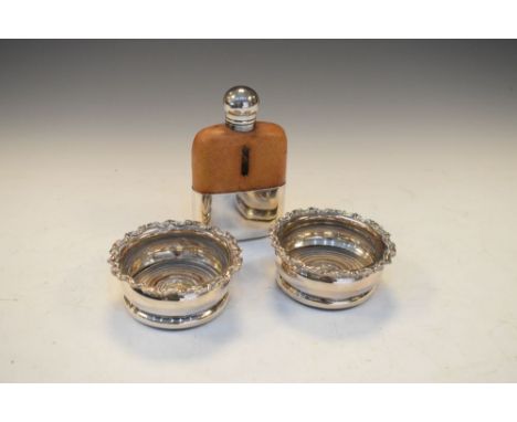 Pair of silver plated wine coasters, 8.5cm diameter and a silver plated hip flask  