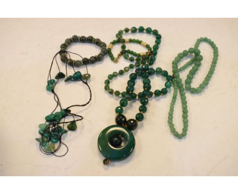 Oval dressing case containing a selection of jade and other hardstone beads, etc  