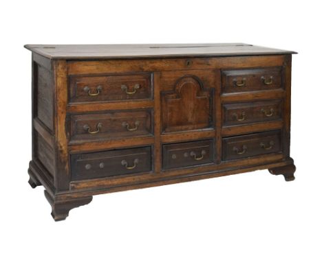 George III oak 'Lancashire' mule chest, the hinged cover over central break-arch fielded panel flanked by two banks of two fa