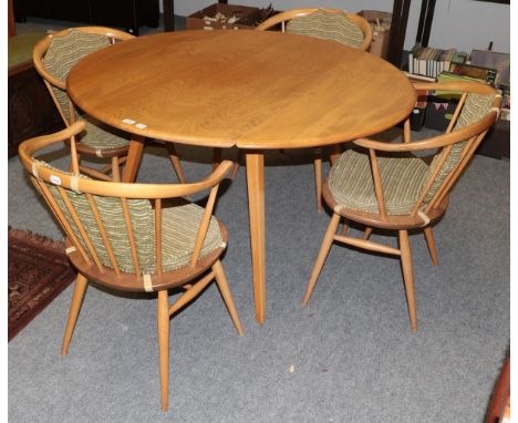 A light elm Ercol drop leaf table 123cm by 114cm by 72cm together with four matching horseshoe back chairs.  Table top with s