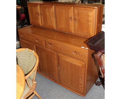 A Ercol light elm sideboard 136cms by 47cms by 125cms