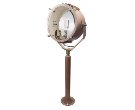 A large copper and brass ship's searchlight:, the 20 inch lamp with concave mirrored reflector in case with double handles to