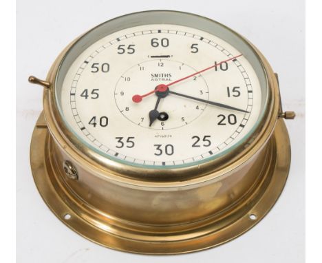 A brass cased bulkhead 'Astral' clock by Smiths:, the dial with Arabic minutes and inner subsidiary hours dial, red sweep sec