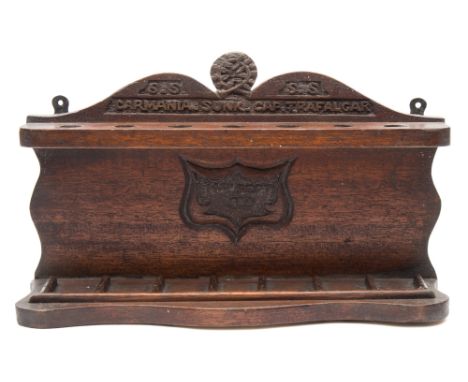A carved wooden pipe rack recovered from the timbers of the WWI armed merchant cruiser RMS Carmania:, inscribed 'SS Carmania 
