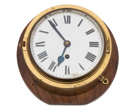 A brass cased bulkhead clock:, 8-day movement with white enamel dial and Roman numerals, bevelled glass bezel, mounted on a w