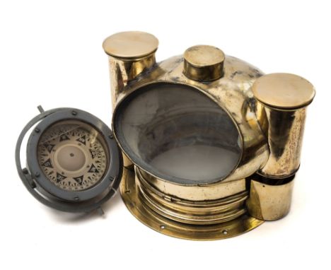 A late 19th/early 20th century brass binnacle:,  the ovoid cover with oval observation window and circular lamp holders to ei
