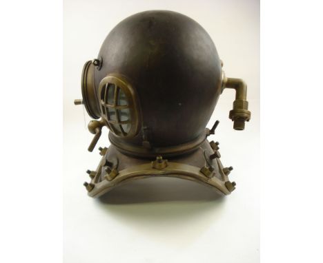 A 12-bolt diving helmet in the manner of Siebe Gorman & Co:, the brass bonnet with oval side windows and guards, the circular