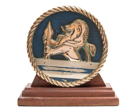 An 8 inch brass tompion from the starboard No 4 QF 5,25-inch  MK1 dual purpose gun of HMS Vanguard:, with demi-lion rampant h