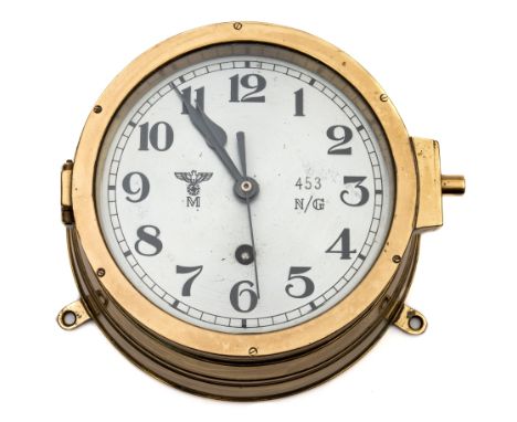 A Third Reich period Kriegsmarine bulkhead clock:, the silvered dial with Roman numerals numbered '453 N/G' with eagle and sw