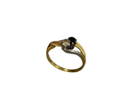 An 18ct yellow gold and platinum ladies ring set with diamond and sapphire, size P, 3.37 grams.