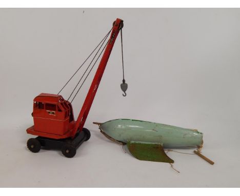 A Star pond yacht, 36cm long, and a Tri-Ang model of a K & L Jones 44 mobile crane, (2).