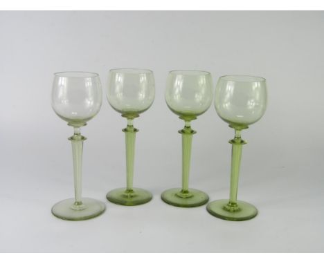A set of four light green hock glasses, raised on spiral air twist stems, 20cm high.