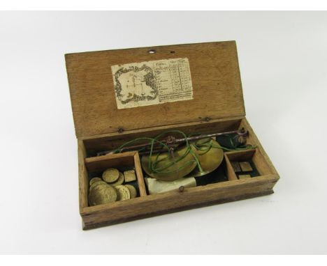 A set of George III brass and steel coin scales, with brass weights, boxed with paper label.