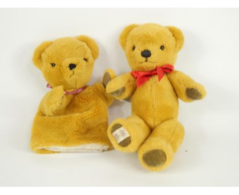 A Merrythought teddy bear, bears label, 32cm long, and a teddy bear glove puppet.