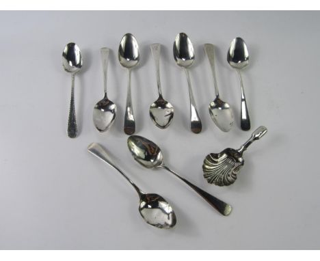 Nine George III silver tea spoons with monogrammed or bright cut decoration, and a Victorian caddy spoon with shell fluted bo