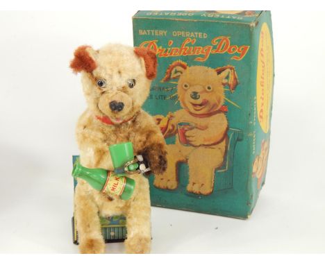 A Japanese tin plate Drinking Dog, it drinks and its eyes light up, pat. 473028, reg no. 6808, boxed.