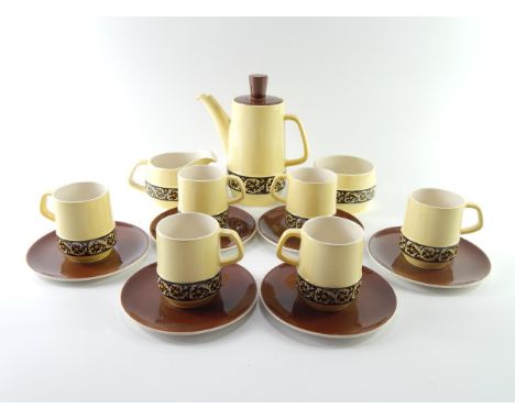 A Carltonware coffee service, comprising coffee pot, six cups and saucers, milk jug and sugar basin, with black bands of foli