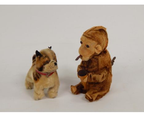 An early 20thC clockwork seated monkey, possibly Steiff, and a Steiff dog, (2).
