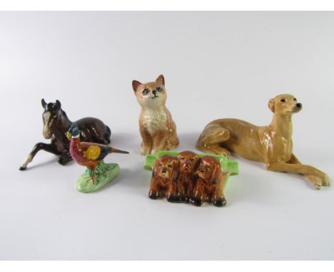 A Beswick three dog ashtray, No 916, recumbent hound, seated cat, recumbent foal and a pheasant, (5).