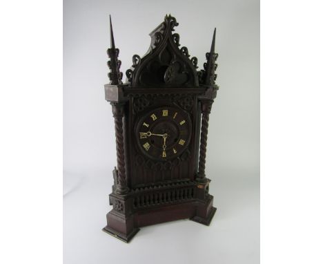 A Black Forest late 19thC Gothic oak cased cuckoo clock, circular dial with chapter ring bearing Roman numerals, eight day mo