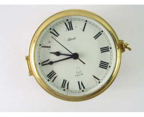 A Hermle brass circular ship's bell clock, battery operated, 18cm diameter.