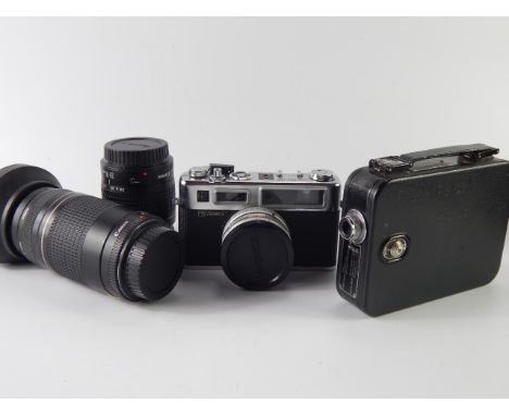 A Yashica G Electro 35 SLR camera, Canon 75-300mm zoom lens, Canon 28-80mm Skylight lens, and Cine camera.