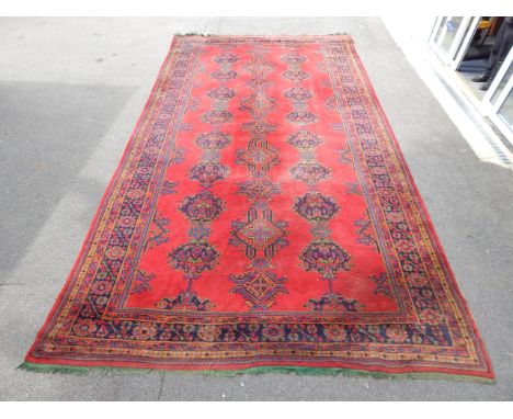 A red ground wool carpet of Turkish design, 573cm x 314cm.